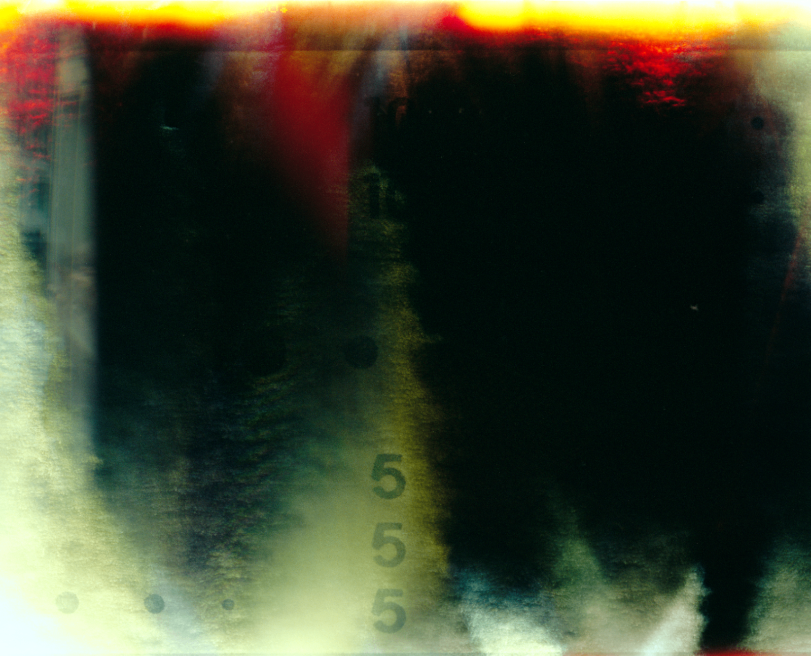 Abstract light-leak photograph with soft vertical forms